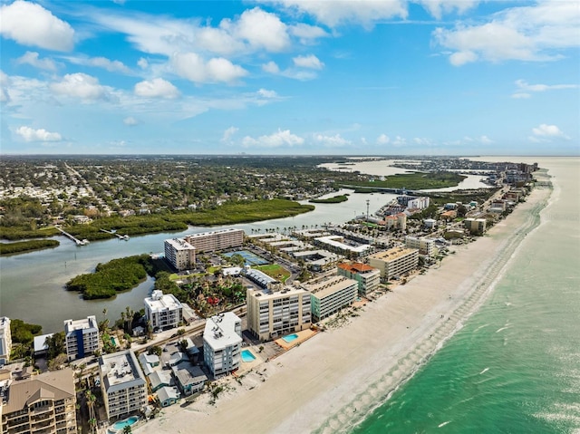 birds eye view of property with a water view and a beach view