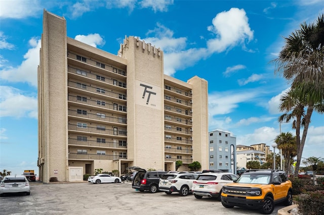 view of building exterior featuring uncovered parking