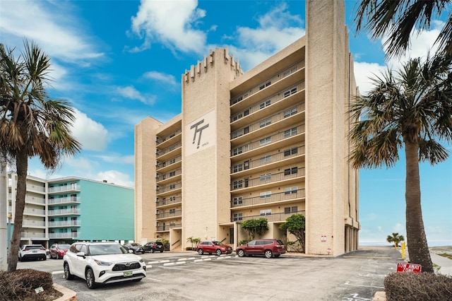 view of building exterior with uncovered parking