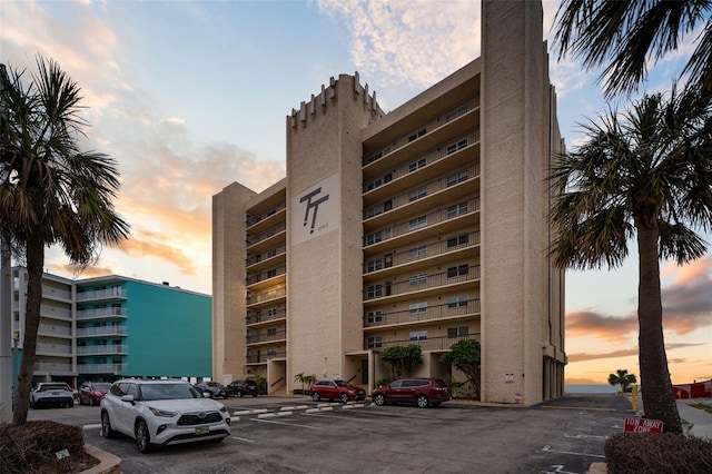 view of building exterior featuring uncovered parking