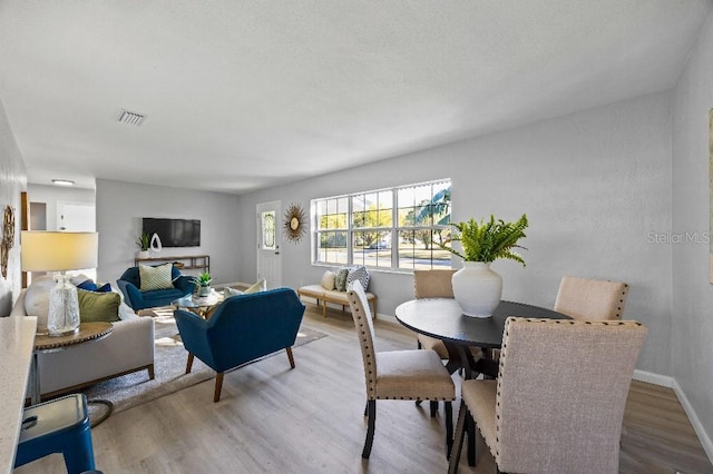 dining space with hardwood / wood-style floors