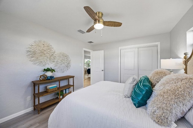 bedroom featuring ceiling fan, hardwood / wood-style flooring, and a closet