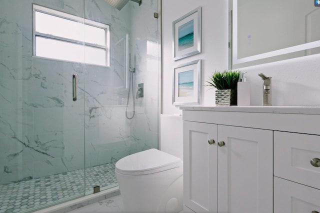 bathroom featuring toilet, a shower with door, and vanity