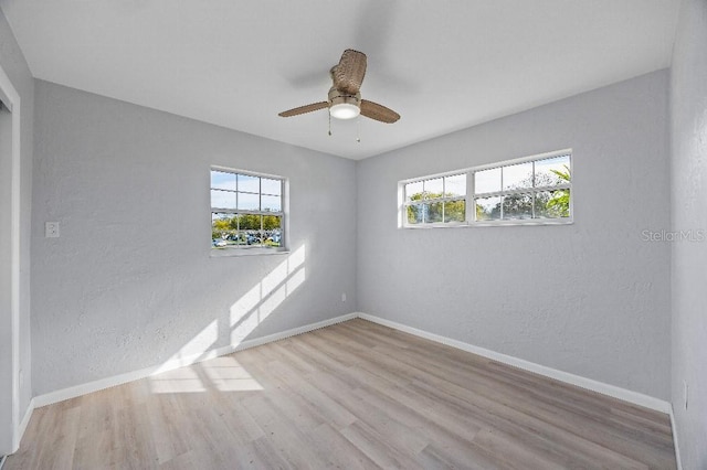 empty room featuring ceiling fan and light hardwood / wood-style floors