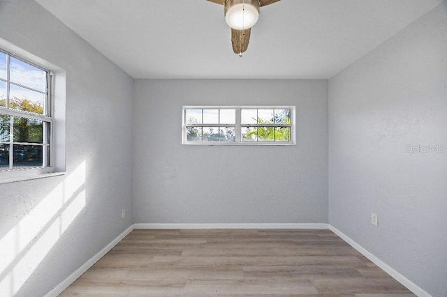 unfurnished room with light wood-type flooring