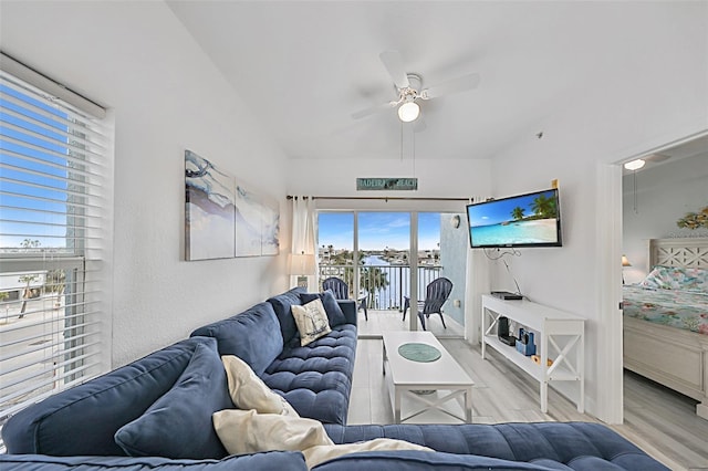 living room with ceiling fan and light hardwood / wood-style floors