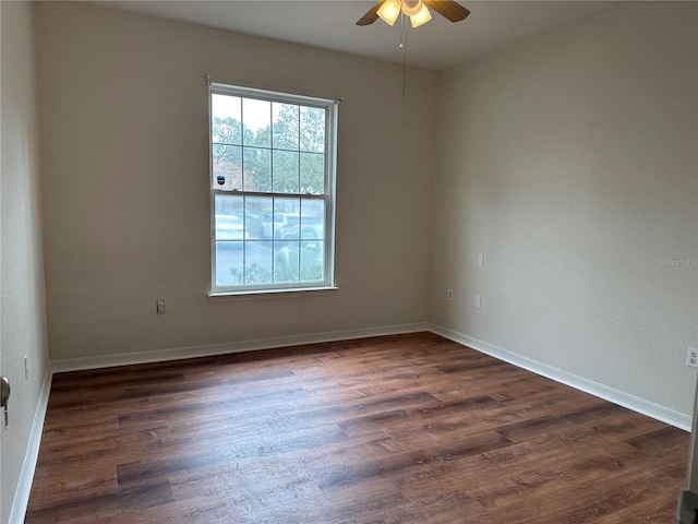 spare room with ceiling fan and dark hardwood / wood-style floors