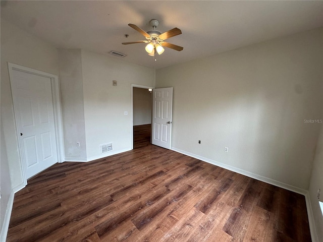 unfurnished bedroom featuring ceiling fan and dark wood-type flooring