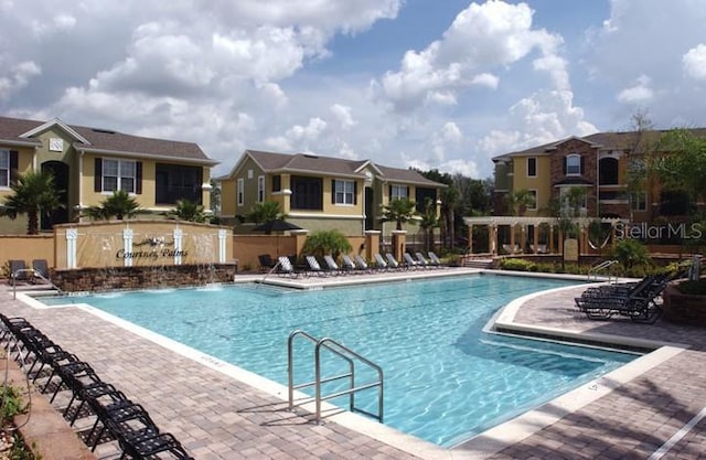 view of pool with pool water feature and a patio area