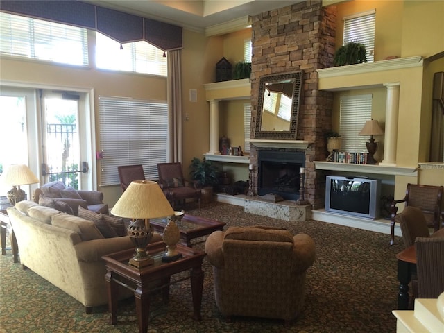 living room with a high ceiling and a fireplace