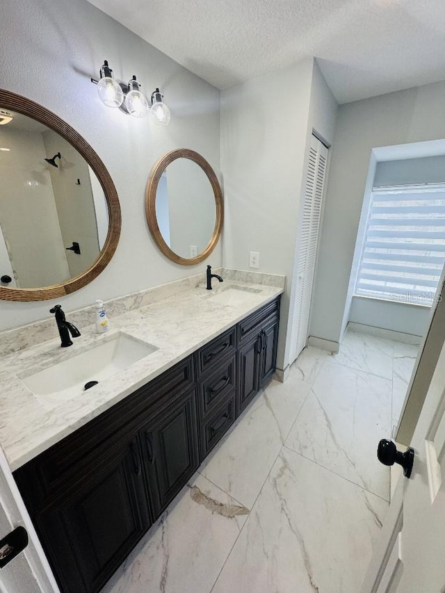 bathroom featuring vanity and a textured ceiling