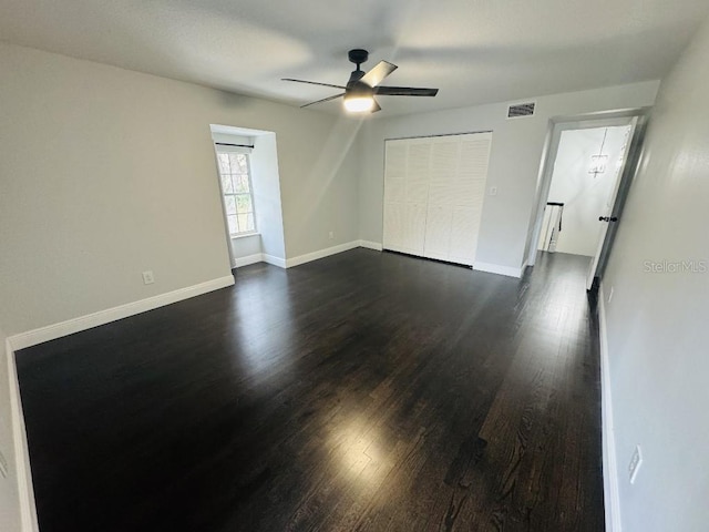 spare room with dark hardwood / wood-style flooring and ceiling fan