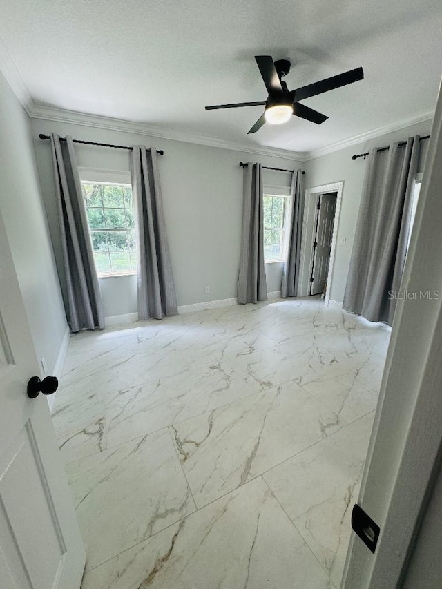 empty room with crown molding and ceiling fan