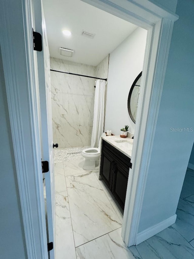 bathroom featuring vanity, toilet, and walk in shower