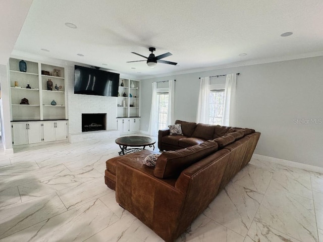 living room featuring a fireplace, ceiling fan, crown molding, a textured ceiling, and built in shelves