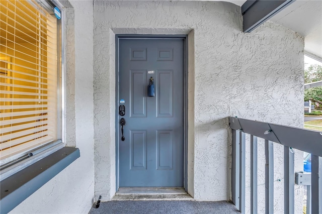 property entrance featuring stucco siding