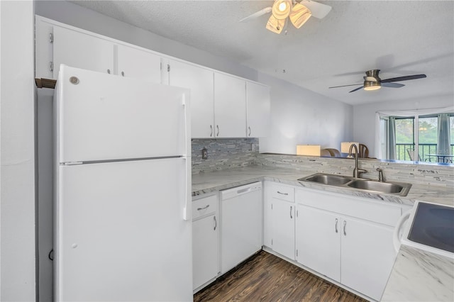 kitchen with white appliances, a sink, light countertops, backsplash, and dark wood-style floors