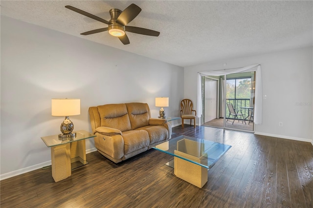 living room featuring hardwood / wood-style flooring, baseboards, and a textured ceiling