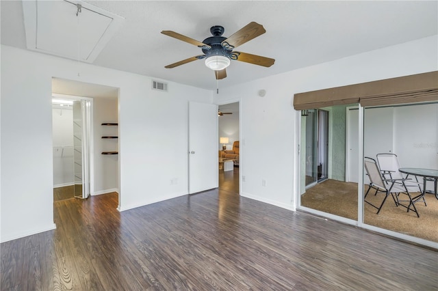 bedroom with attic access, baseboards, visible vents, a ceiling fan, and wood finished floors