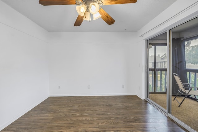 unfurnished room with dark wood-style flooring and baseboards