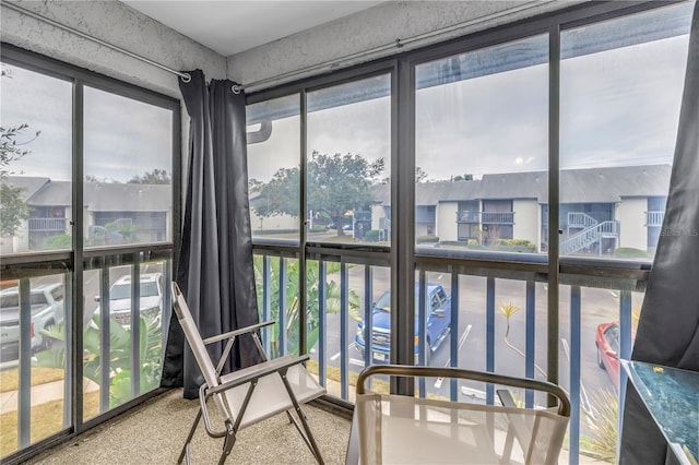 sunroom / solarium featuring a residential view