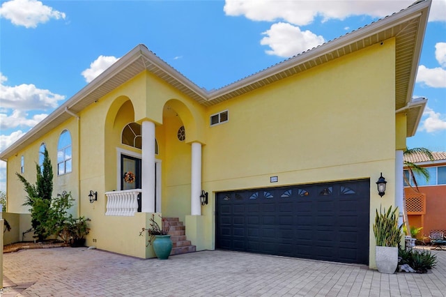 mediterranean / spanish-style home with a garage