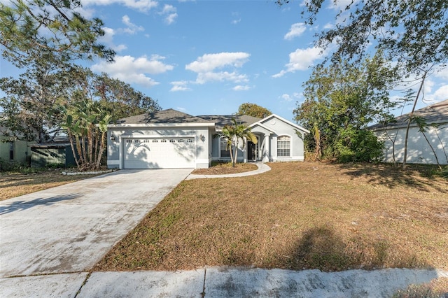 ranch-style home featuring a front lawn and a garage