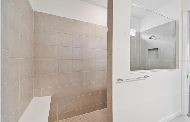 bathroom featuring a tile shower