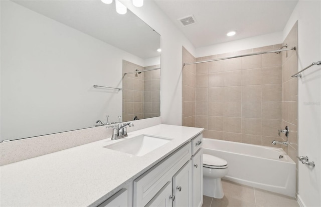 full bathroom featuring tiled shower / bath combo, toilet, tile patterned floors, and vanity