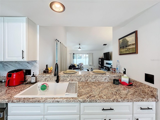 kitchen with white cabinets, ceiling fan, and sink