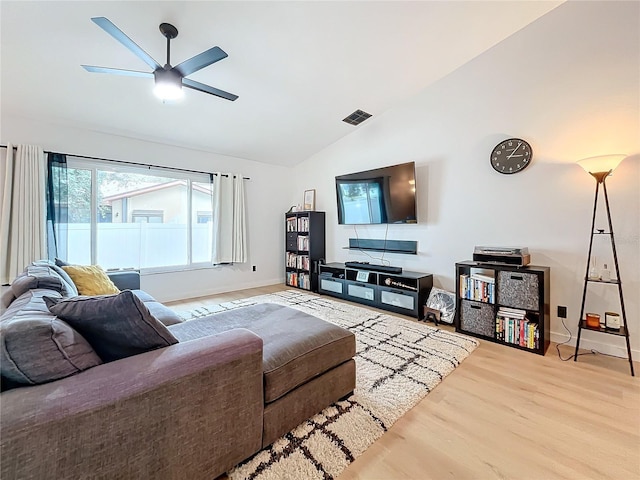 living room with lofted ceiling, ceiling fan, and hardwood / wood-style flooring