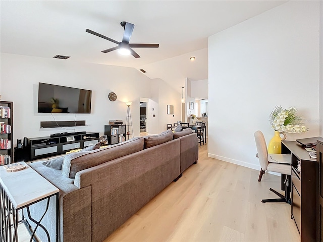 living room featuring vaulted ceiling, ceiling fan, and light hardwood / wood-style floors