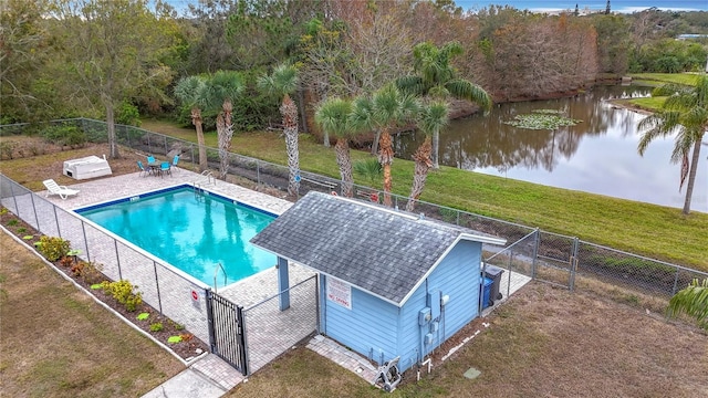 view of pool with a patio area, a lawn, and a water view