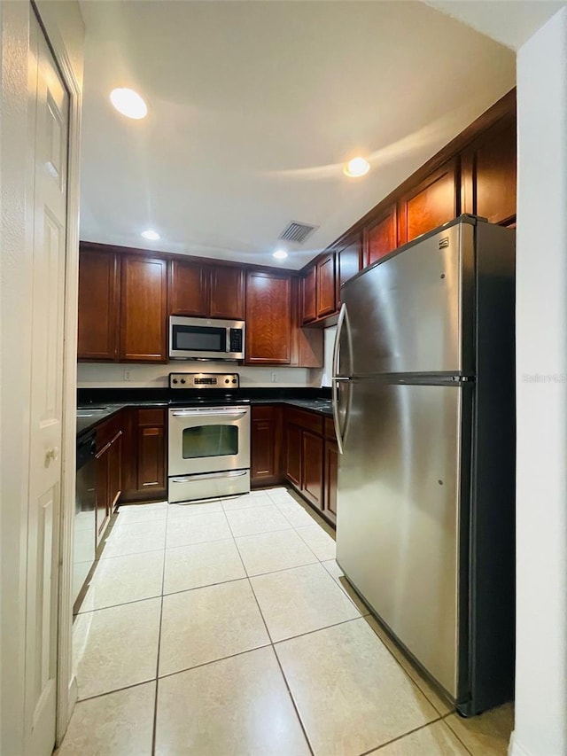 kitchen featuring appliances with stainless steel finishes and light tile patterned flooring