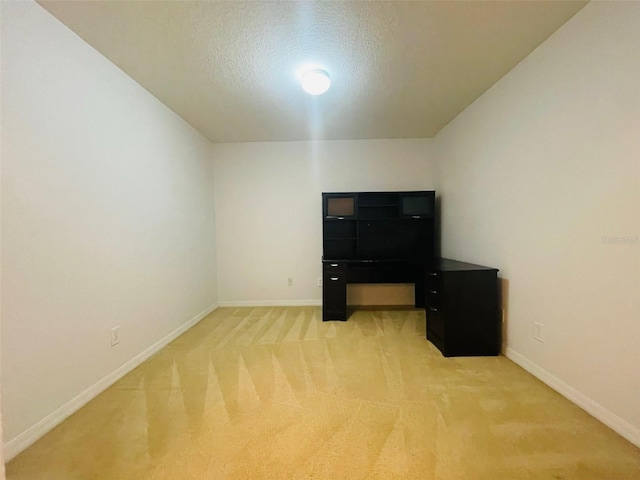 carpeted empty room featuring a textured ceiling