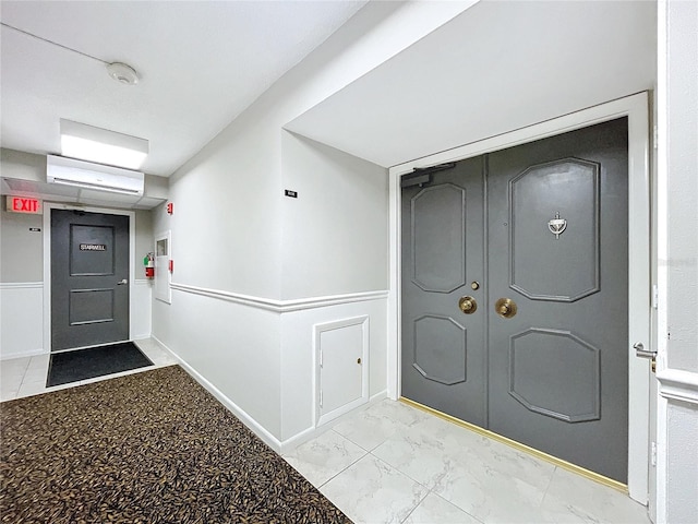 foyer featuring a wall unit AC