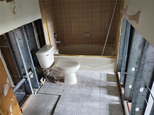 bathroom featuring toilet and tiled shower / bath combo