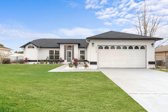 ranch-style house featuring a front yard and a garage