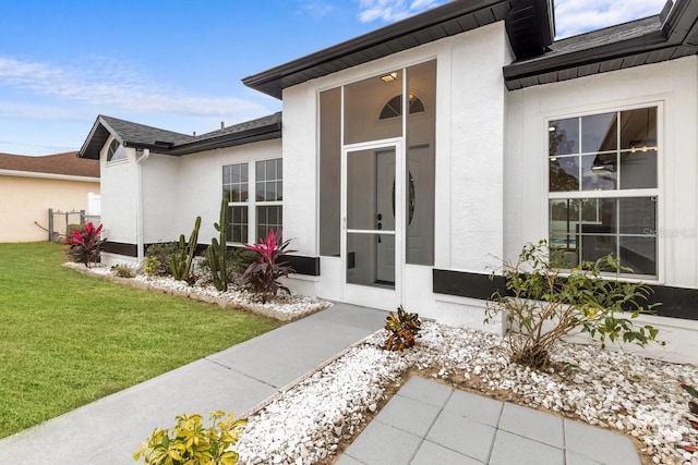 doorway to property with a yard