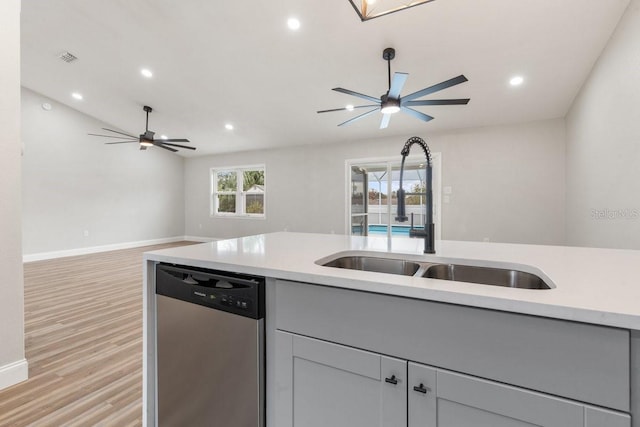 kitchen featuring sink, ceiling fan, light hardwood / wood-style flooring, stainless steel dishwasher, and gray cabinetry