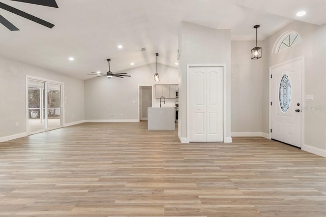 entrance foyer featuring high vaulted ceiling, ceiling fan, and light hardwood / wood-style flooring