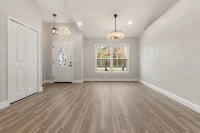 entrance foyer with an inviting chandelier and light wood-type flooring