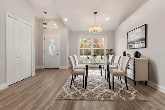 dining room with a chandelier and wood-type flooring