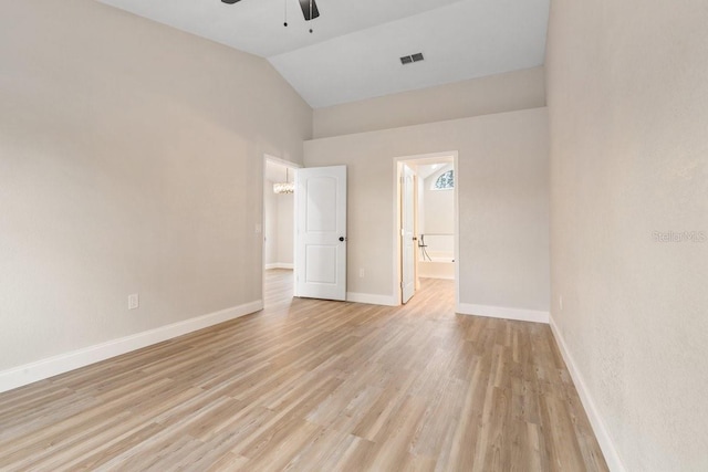 empty room featuring ceiling fan, light wood-type flooring, and lofted ceiling