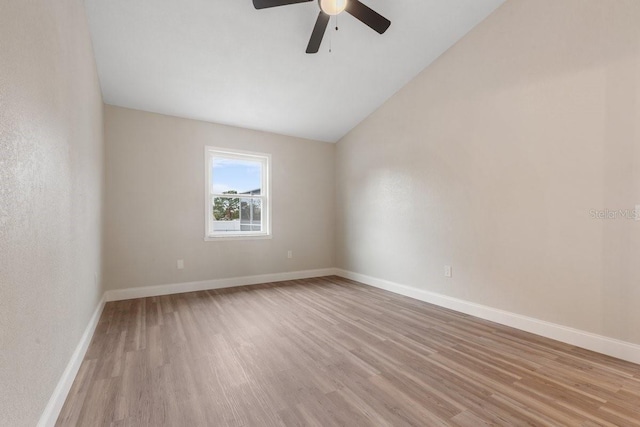 unfurnished room with lofted ceiling, ceiling fan, and light hardwood / wood-style floors