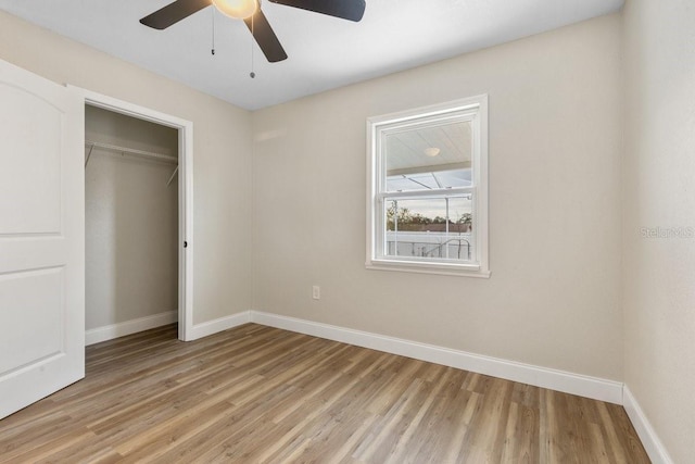 unfurnished bedroom with ceiling fan, light hardwood / wood-style flooring, and a closet