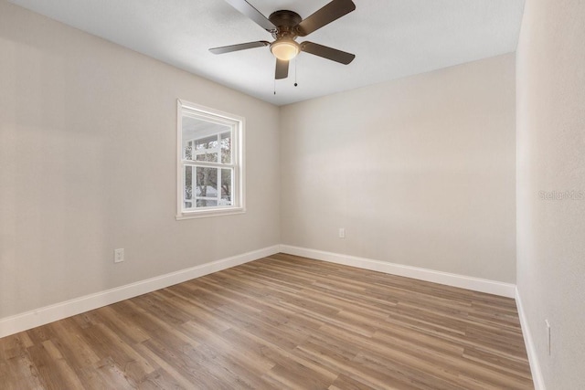 spare room with ceiling fan and hardwood / wood-style flooring