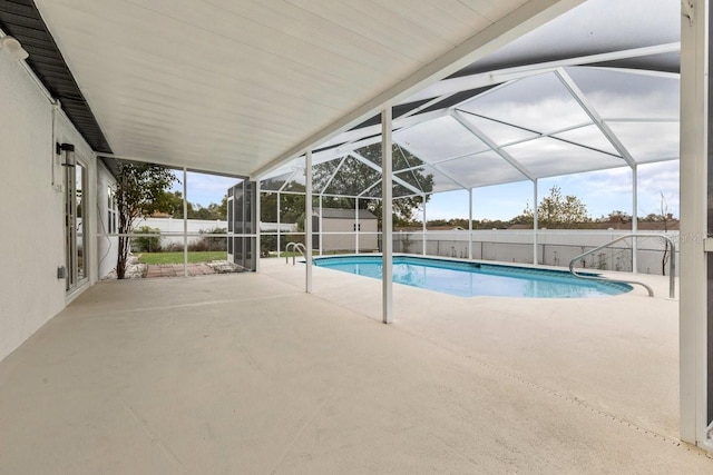 view of pool featuring a patio area, glass enclosure, and a shed