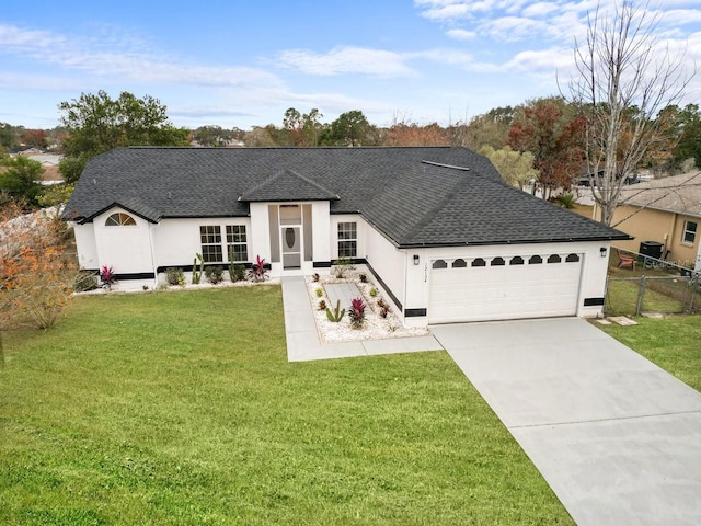 view of front facade featuring a front lawn and a garage