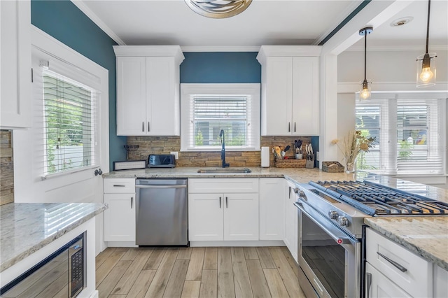 kitchen with stainless steel appliances, white cabinetry, and sink